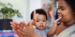 a parent and child clapping together