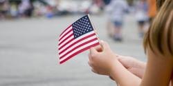 a child holding an american flag