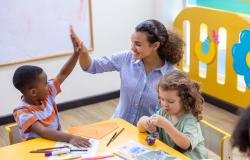 a teacher giving a child a high five