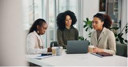 A group of women at a conference table