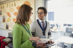 Two teachers talking in school