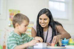 A teacher helping a student in the classroom