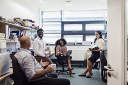 Teachers meeting with each other in the break room