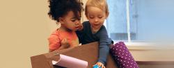Two toddlers playing with materials