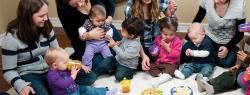 Parents sitting in half circle with toddler children