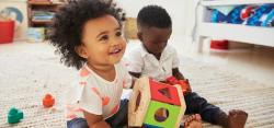 Two toddlers playing with toys