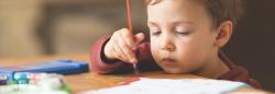 Boy holding a paintbrush