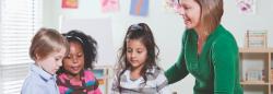 Teacher observing three students 