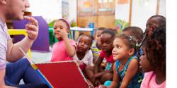 children listen attentively to teacher in class