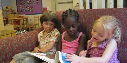 children reading books together at a home childcare facility