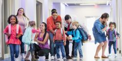 Young children leaving their teachers and classrooms