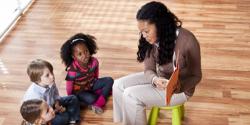 young students listen to teacher tell a story