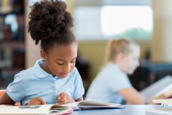 A young child reading a book.