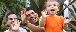 two parents clapping with a toddler