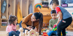 a teacher observing children playing with blocks