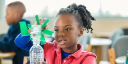 A child working on a project in a classroom