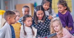 Image of a teacher reading to a group of students