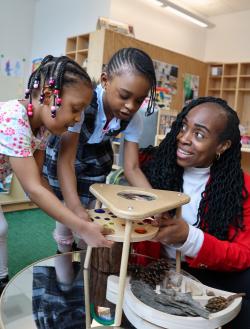 Carlyn Rahynes building blocks with children in a classroom