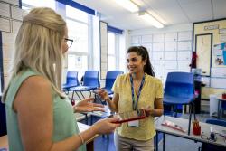 Two teacher talking in a classroom