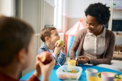 An educator and student eating lunch together