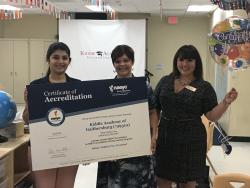 Kiddie Academy staff and NAEYC Accreditation team pose for a picture with accreditation certificate.