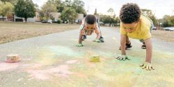 Children playing with chalk outdoors