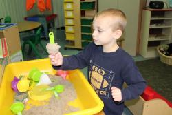 Boy playing in sand table