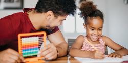 Father and daughter doing math activities