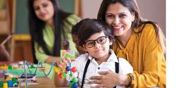 Teacher and student posing for an image while playing and doing puzzles