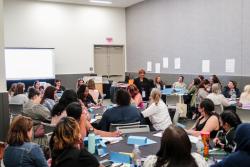 a group of conference attendees in a panel room