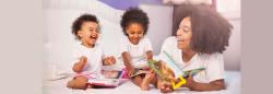 Mother reading with toddler girls