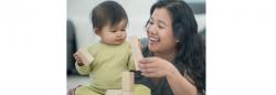 Infant and mother playing with blocks