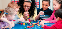 Teacher helping students build 