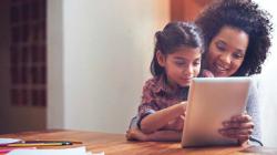 Mom and child reading from tablet