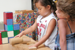 Two girls playing with blocks in classroom