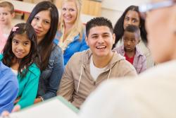 Adults and children in a learning environment.