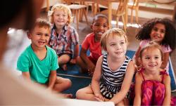 Children gathered on the play mate.