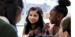 Group of children talking to a teacher