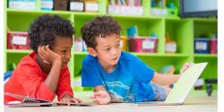 Two children reading on the floor