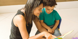 a parent or teacher reading with a child