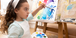 a child painting in class