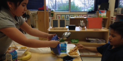 children helping each other in class