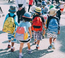 Children wearing backpacks head back to school.