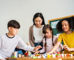 A teacher and students working with blocks