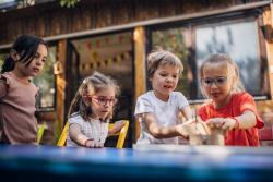 Young children working on a project together outside