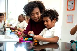 A teaching working with a student