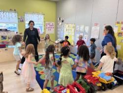 Children and teachers in a circle in class