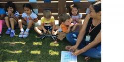 Teacher and students sitting outside