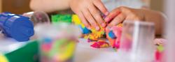 child's hands kneading playdough