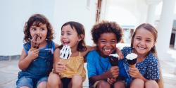 Group of diverse young children eating ice cream